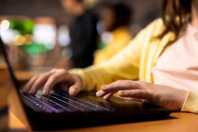 primary-school-student-sitting-desk-campus-library-writing-laptop_482257-123275.jpg