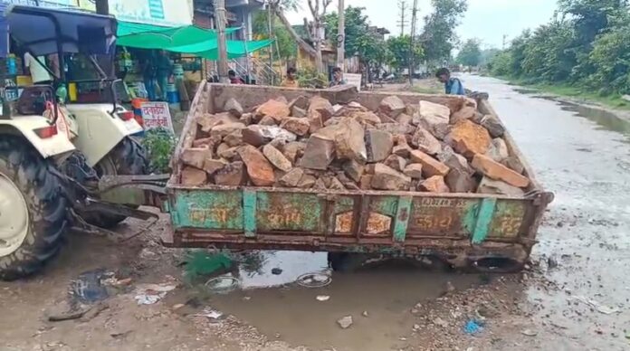404 गड्ढे में धंसा पत्थरों से भरा ट्रैक्टर